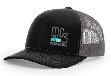 Black mesh trucker hat with MG3 Botanicals logo.