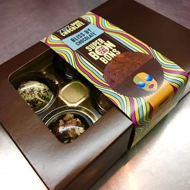 Box of assorted Bliss by Chocolate superbrown boxes with colorful packaging.