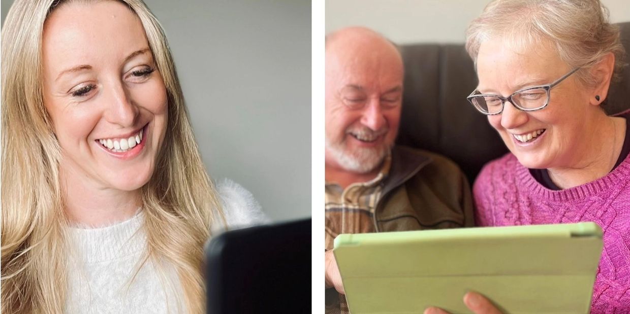 A young woman smiling at her tablet screen.