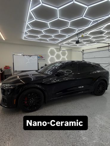 Black car with nano-ceramic coating in a modern garage. tinted windows with ceramic tint