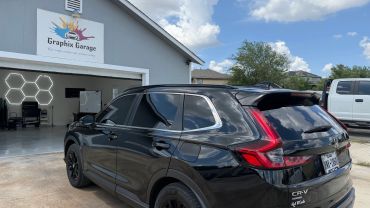 Black Honda CR-V parked outside Graphix Garage.
