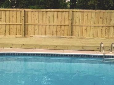 Privacy wood Fence panels that were installed around a wooden deck that was built.