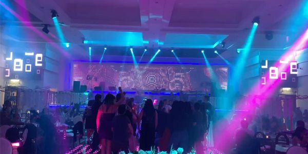 A vibrant nightclub scene with colorful lights and dancing crowd.
