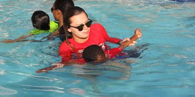 The Swim Center instructor teaches child how to swim in McDonough GA Henry county best swim lessons