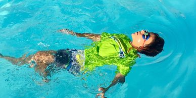 The Swim Center instructor teaches child how to float in Stockbridge GA Henry county best lessons
