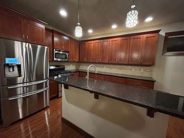 Modern kitchen with wooden cabinets and stainless steel appliances.