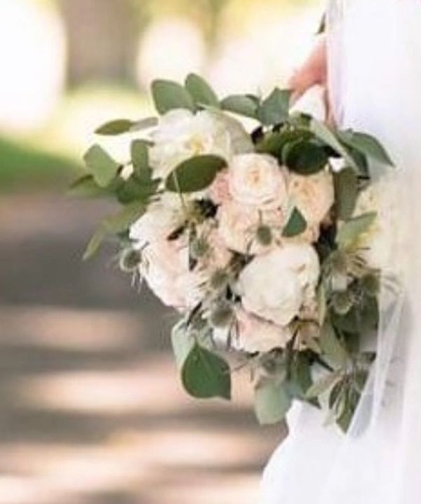 Bridal bouquet with white roses and greenery.