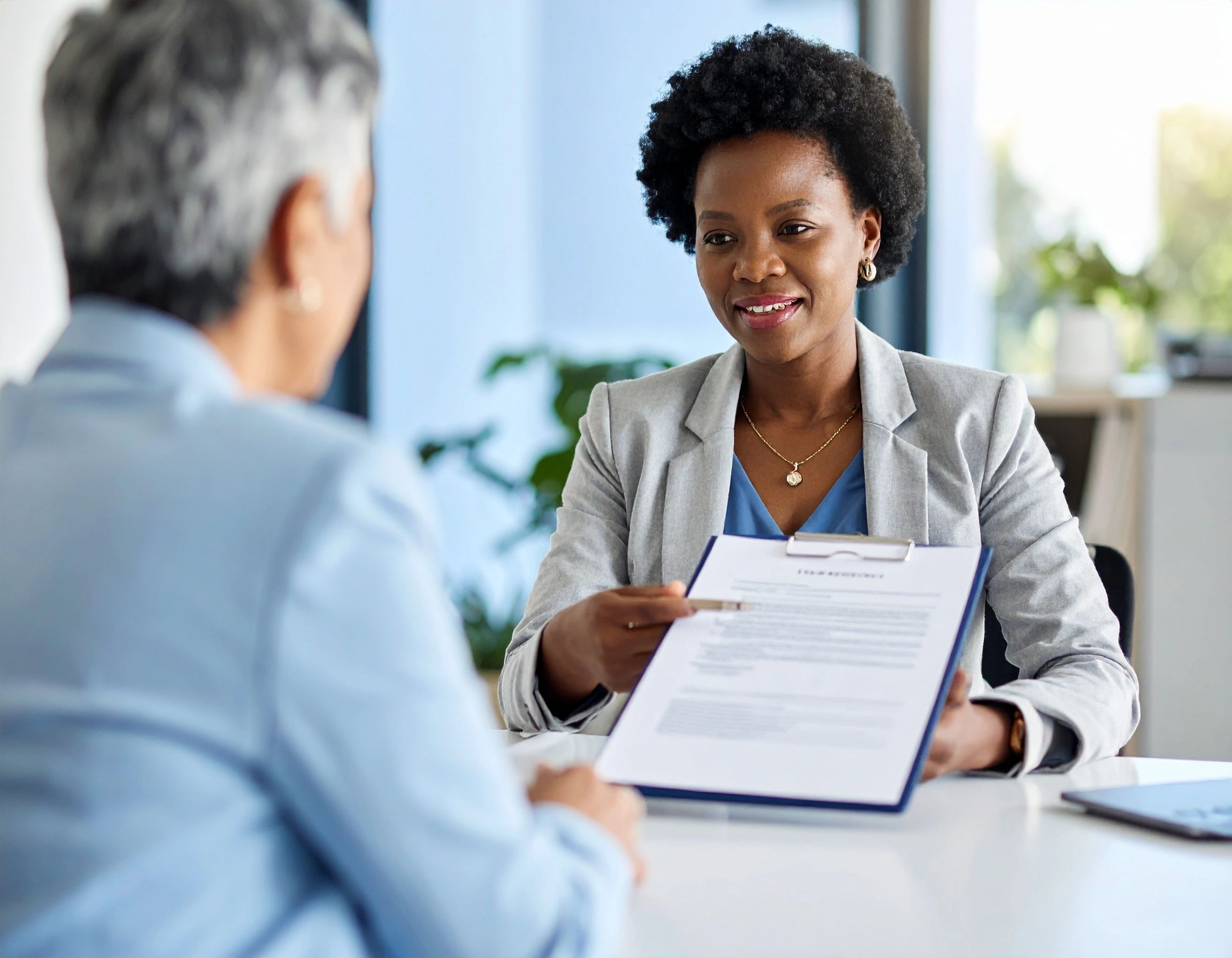 a professional woman going over a contract with a client