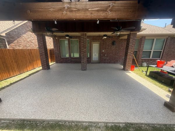 Covered patio area with brick columns and ceiling fans.