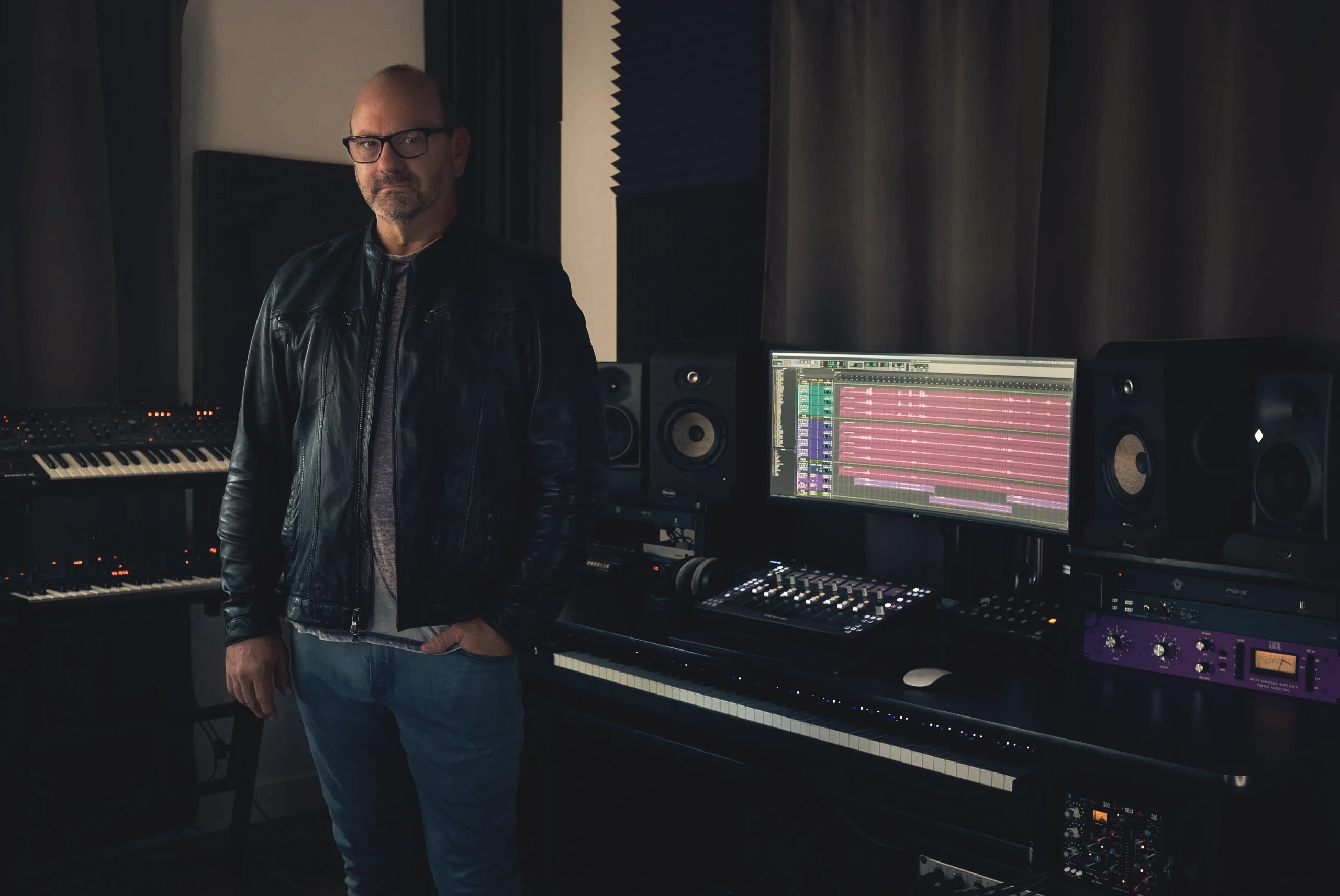 Seth Hancock standing inside his Los Angeles  based music and composing music production studio.