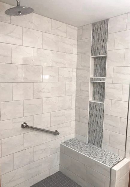 Walk-In Tiled Shower with Custom Shower tile bench and niche boxes and shelving for the shower.