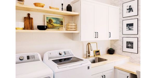 Organized laundry room with shelves, labeled bins, for a streamlined space.