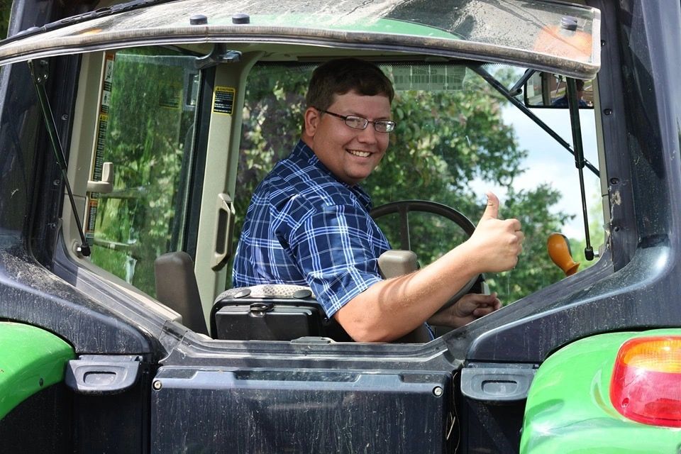Rancher Dirk Dempsey gives you a thumbs up from the cab of the tractor 