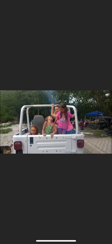 kids in the jeep on the river