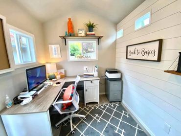 Cozy home office with modern desk, ergonomic chair, and motivational decor.