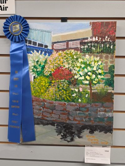Award-winning painting of a garden with flowers and a brick wall.