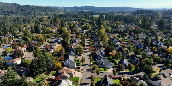 Aerial view of a suburban neighborhood surrounded by trees.
