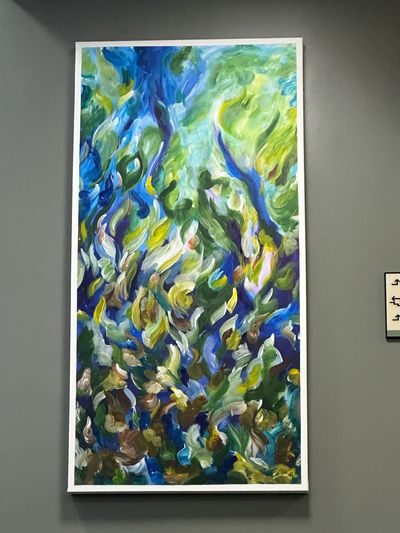 Abstract painting with swirling blue, green, and yellow hues.