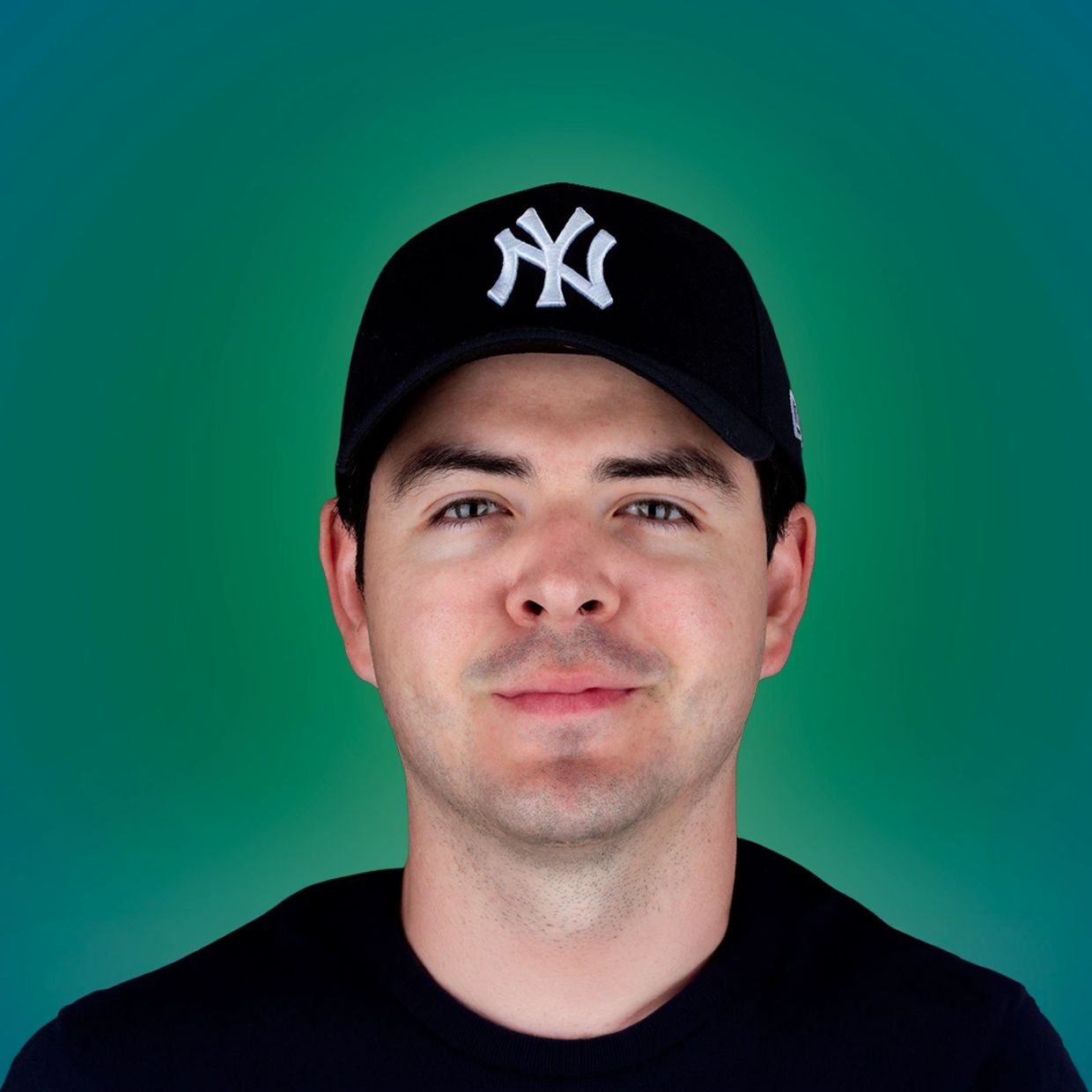Young man wearing a black New York Yankees cap against a green background.