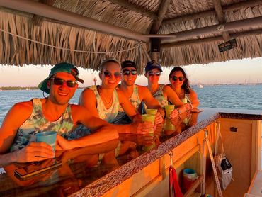Friends celebrating  on a sunset cruise with tiki boat adventures Key West