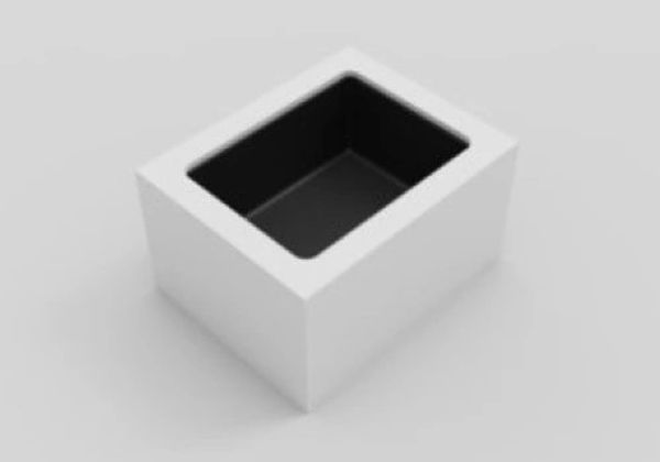 A white rectangular box with a black hollow interior on a gray surface.