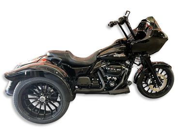 Sleek black Harley-Davidson trike with custom design and intricate details.