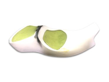 White ceramic spoon rest with green and black design.