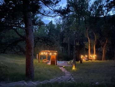 Outside at dusk with the pool decking lit up with solar lights