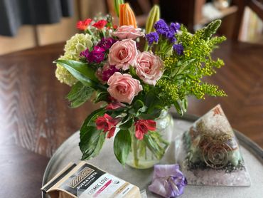 Fresh flowers, local coffee, and orgonite on table to greet guests