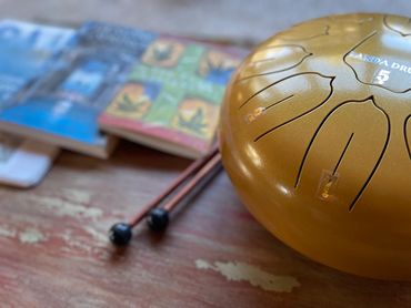 Panda music drum, The Four Agreements, Don Miguel Ruiz book on coffee table for guests entertainment