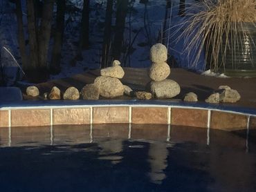 rocks stacked as meditation next to hot spring pool