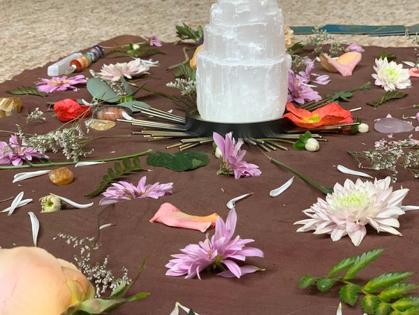 Crystals & flowers displayed into a mandala during a group meditation workshop