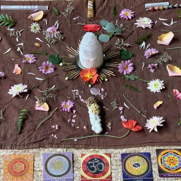 Flower mandala with selenite crystal tower in center during a meditation workshop & day retreat
