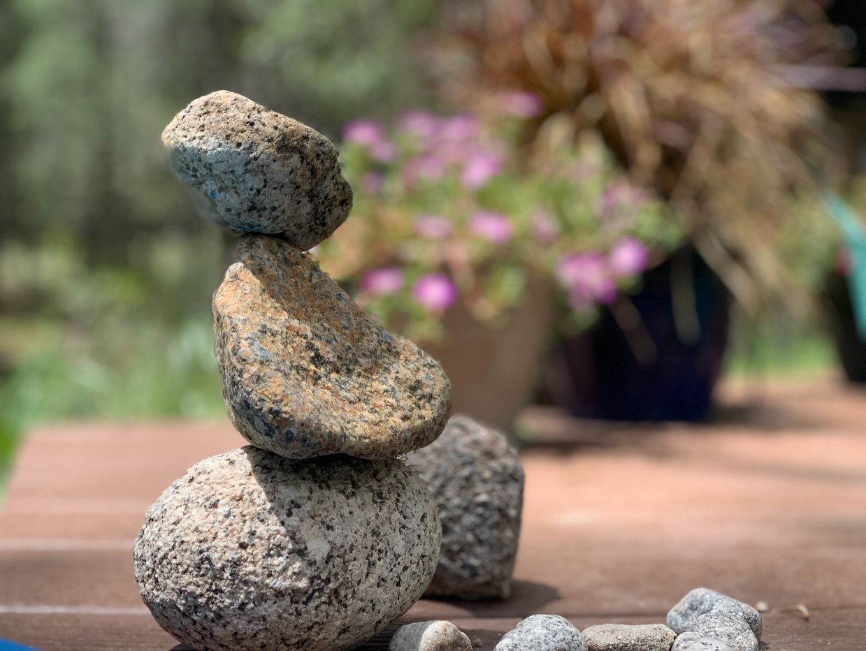 three rocks balanced to look like an angel during a hot spring soak meditation