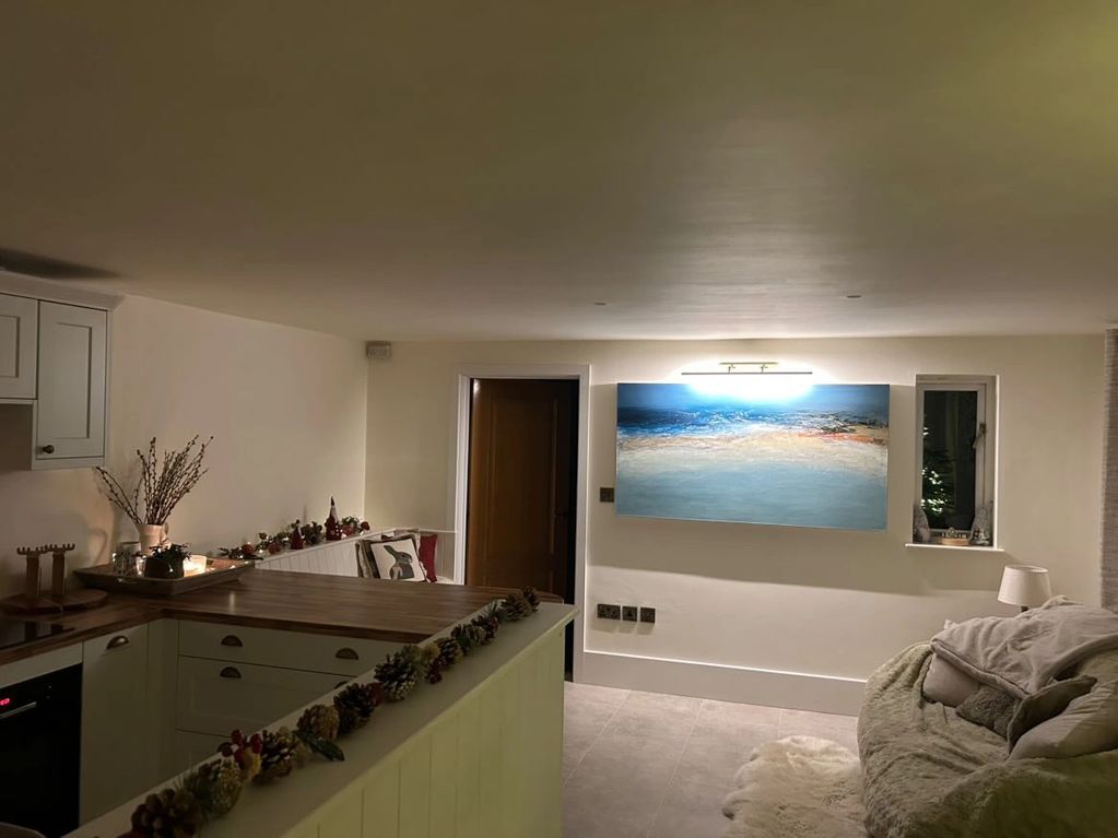 showing a large seascape painting as a centre piece of a new kitchen