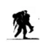 A silhouette of a person carrying a large backpack.