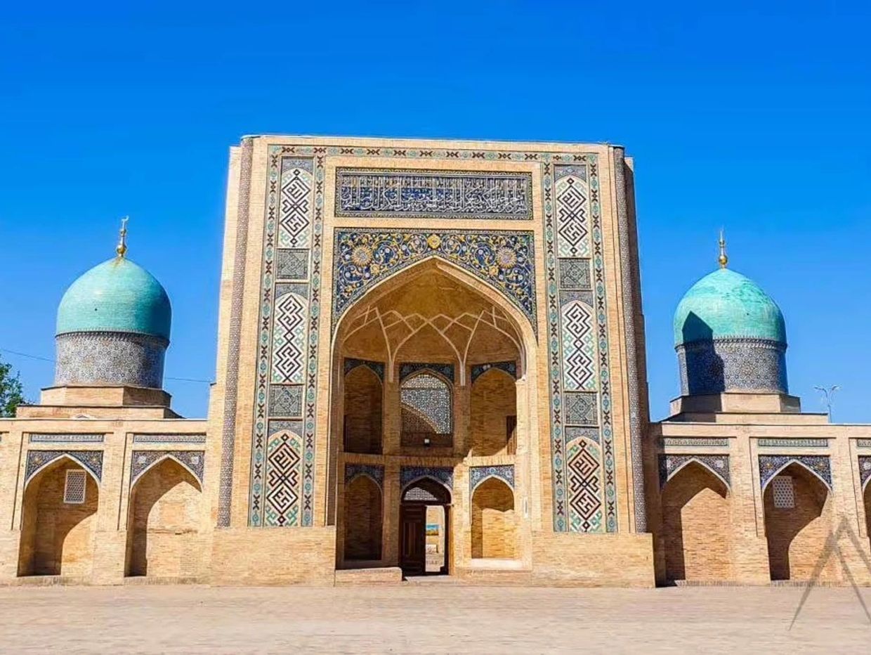 Historic Islamic architecture with intricate blue tilework and turquoise domes.