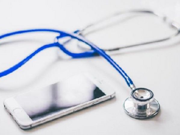 Stethoscope and smartphone on a white surface.