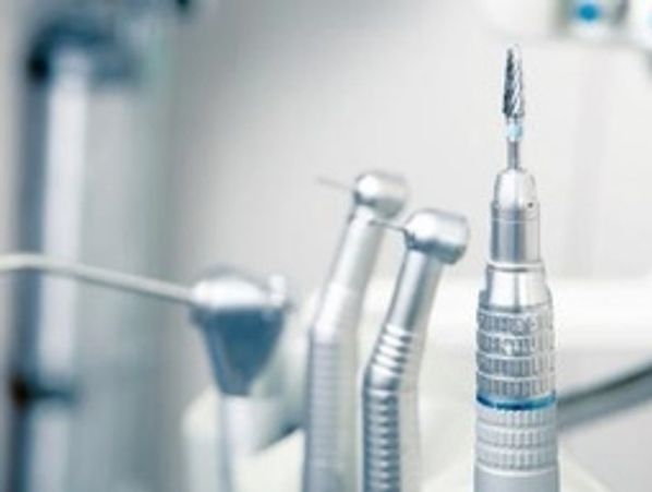 Dental handpieces and drill bit closeup.