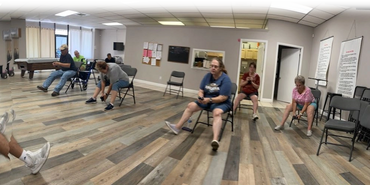 Seniors exercising with resistance bands indoors.
