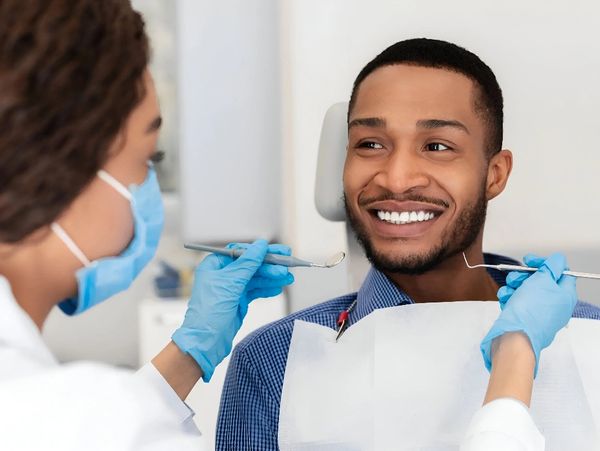 Young man smiling during dental checkup.