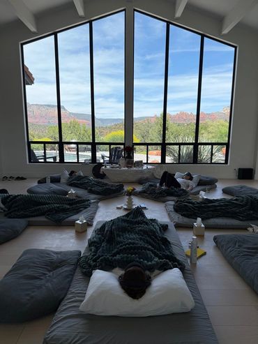 Participants experiencing a guided psychedelic journey in a comfortable, safe group setting with flo