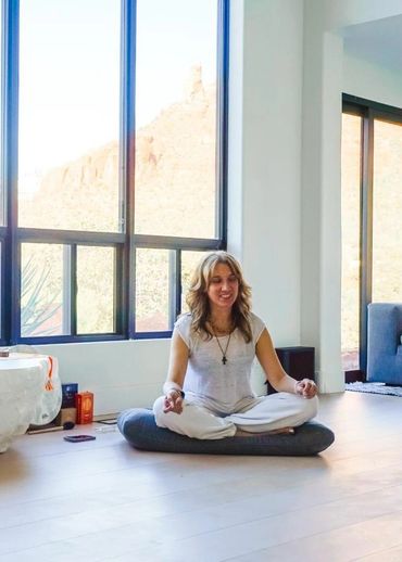 Facilitator Sonia Doulton leading a meditation session during a legal psilocybin retreat at Ad Maior