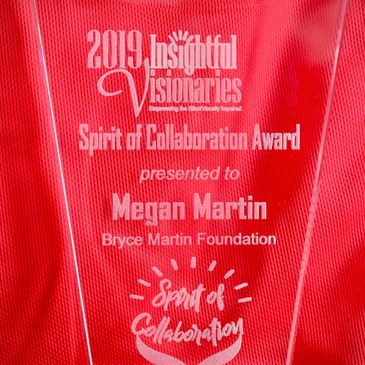 The glass award sits in front of a red background.