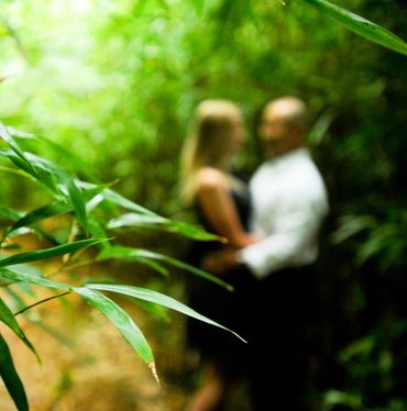 Maui Couple looking at each other in Maui Bamboo forest.