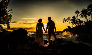Maui couple looking into the sun at Makena Cove.