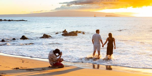 Maui Photographer taking a photo of a couple on maui beach.