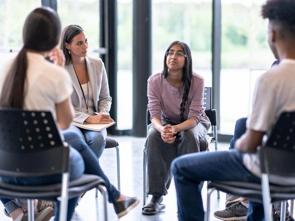 Group therapy session with focused listening.