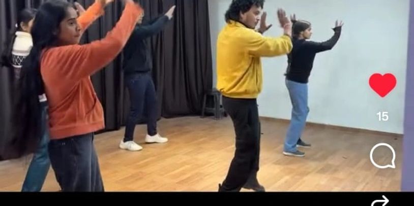 A group of people doing Zumba in a dance studio.