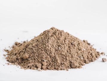 A pile of fine brown powder on a white surface.